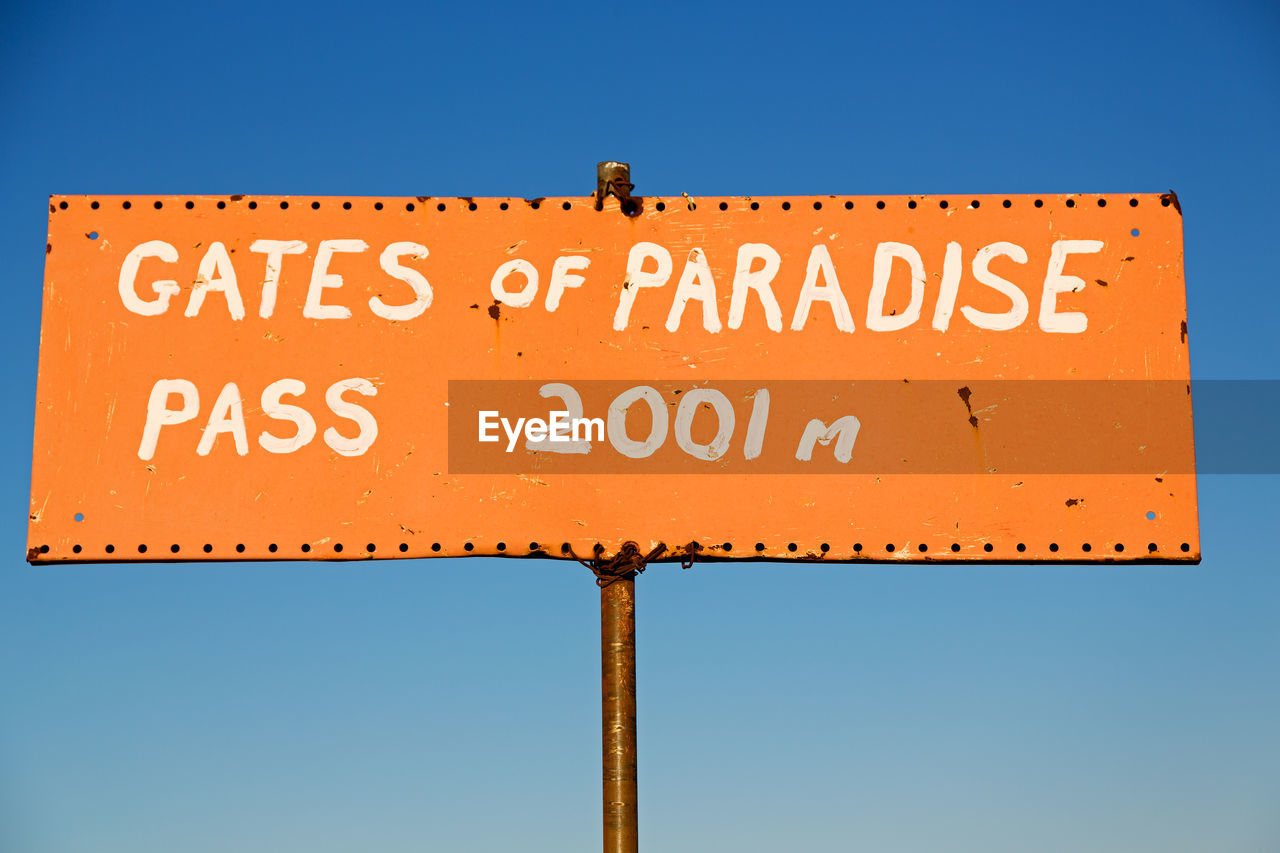 LOW ANGLE VIEW OF ROAD SIGN AGAINST CLEAR SKY
