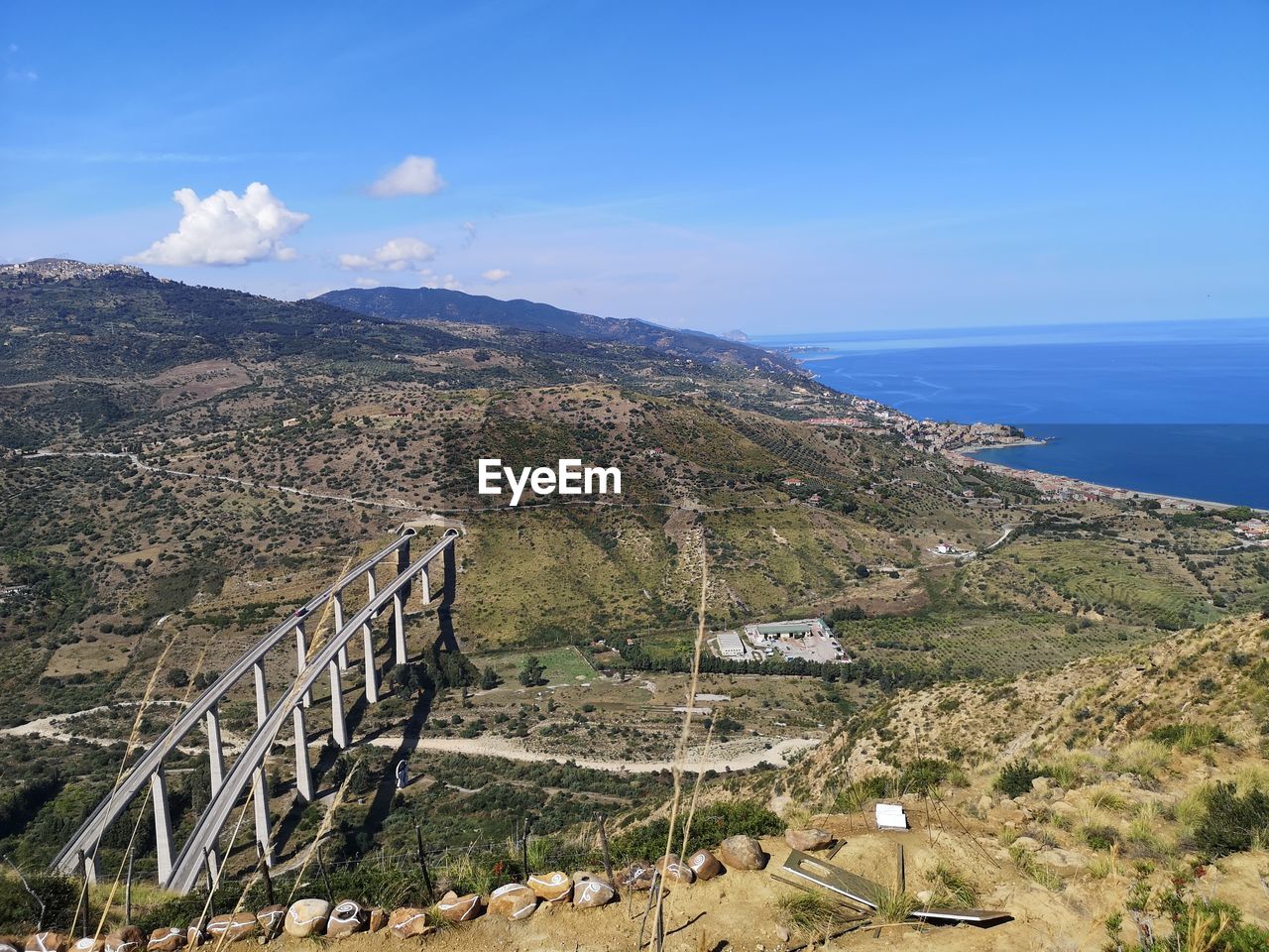 High angle view of sea and mountains against sky