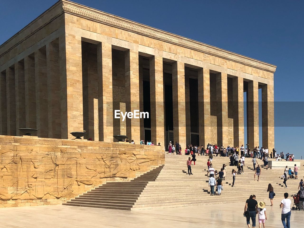 Tourists visiting an?tkabir against clear blue sky during sunny day