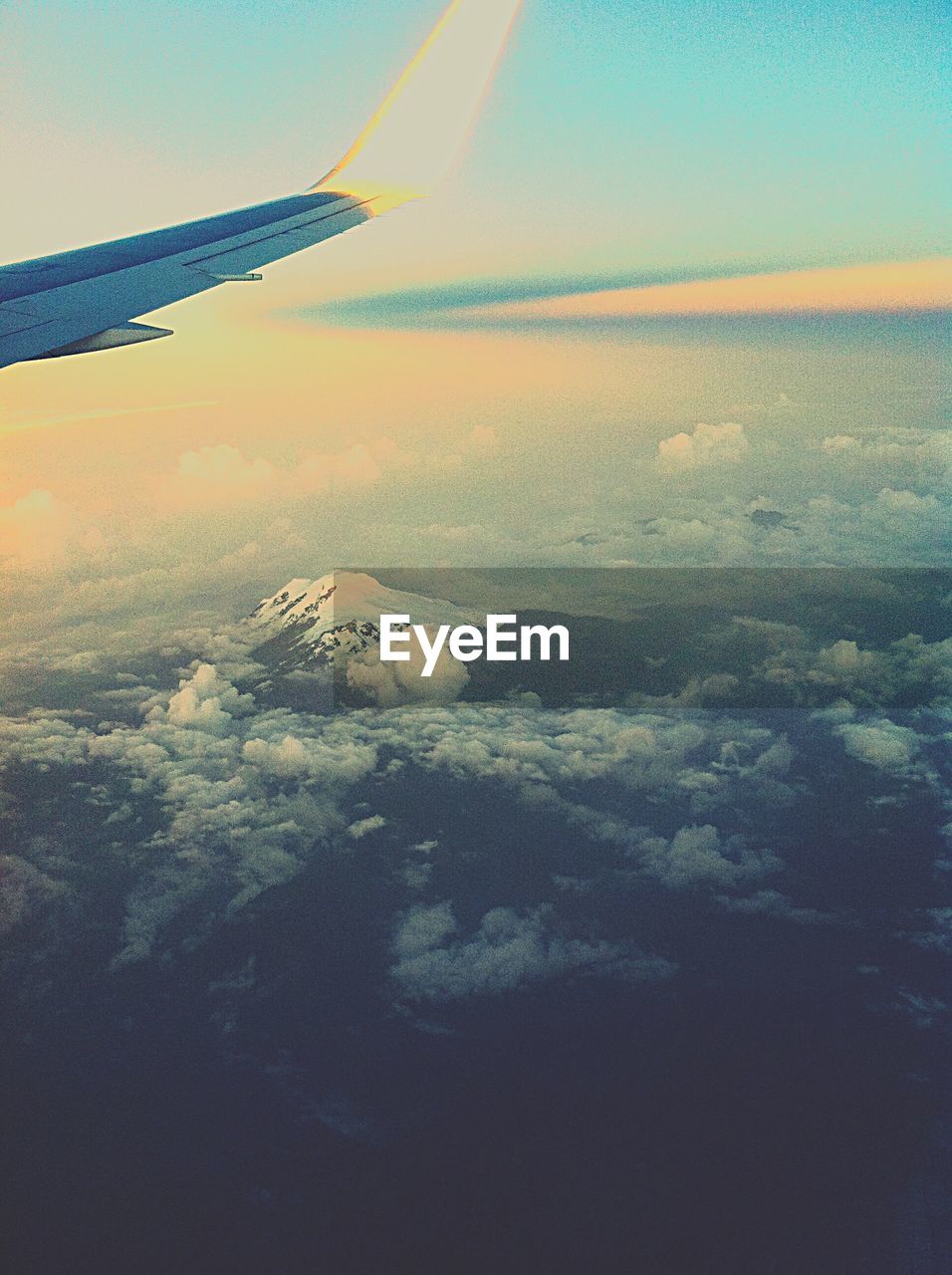 AERIAL VIEW OF AIRCRAFT WING OVER CLOUDS