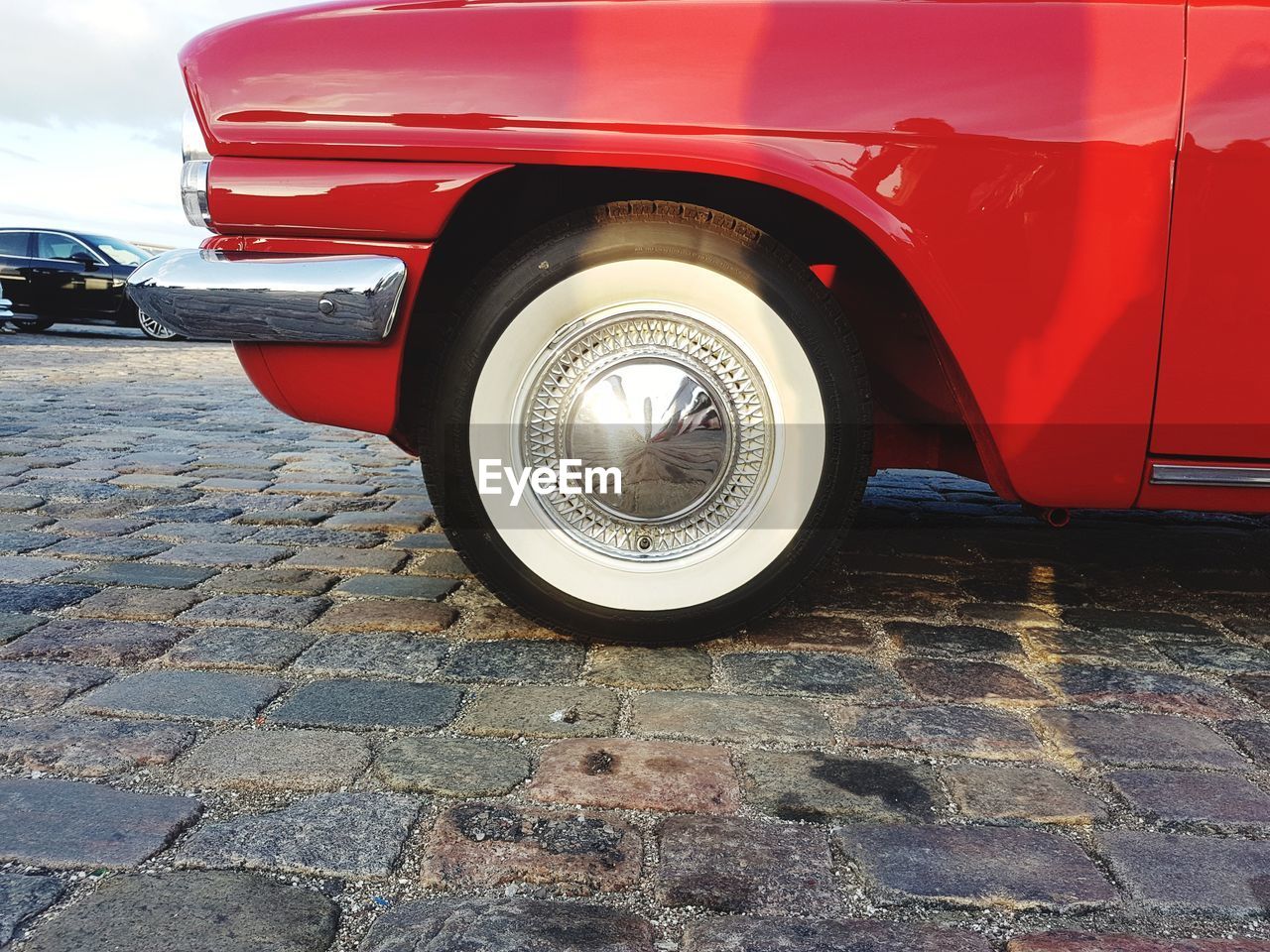 CLOSE-UP OF RED VINTAGE CAR ON TRUCK