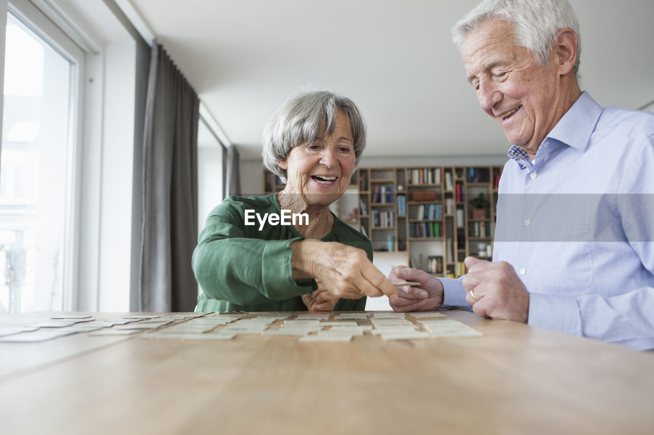 Senior couple playing memory at home