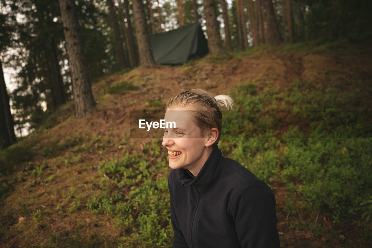 Happy woman relaxing in forest