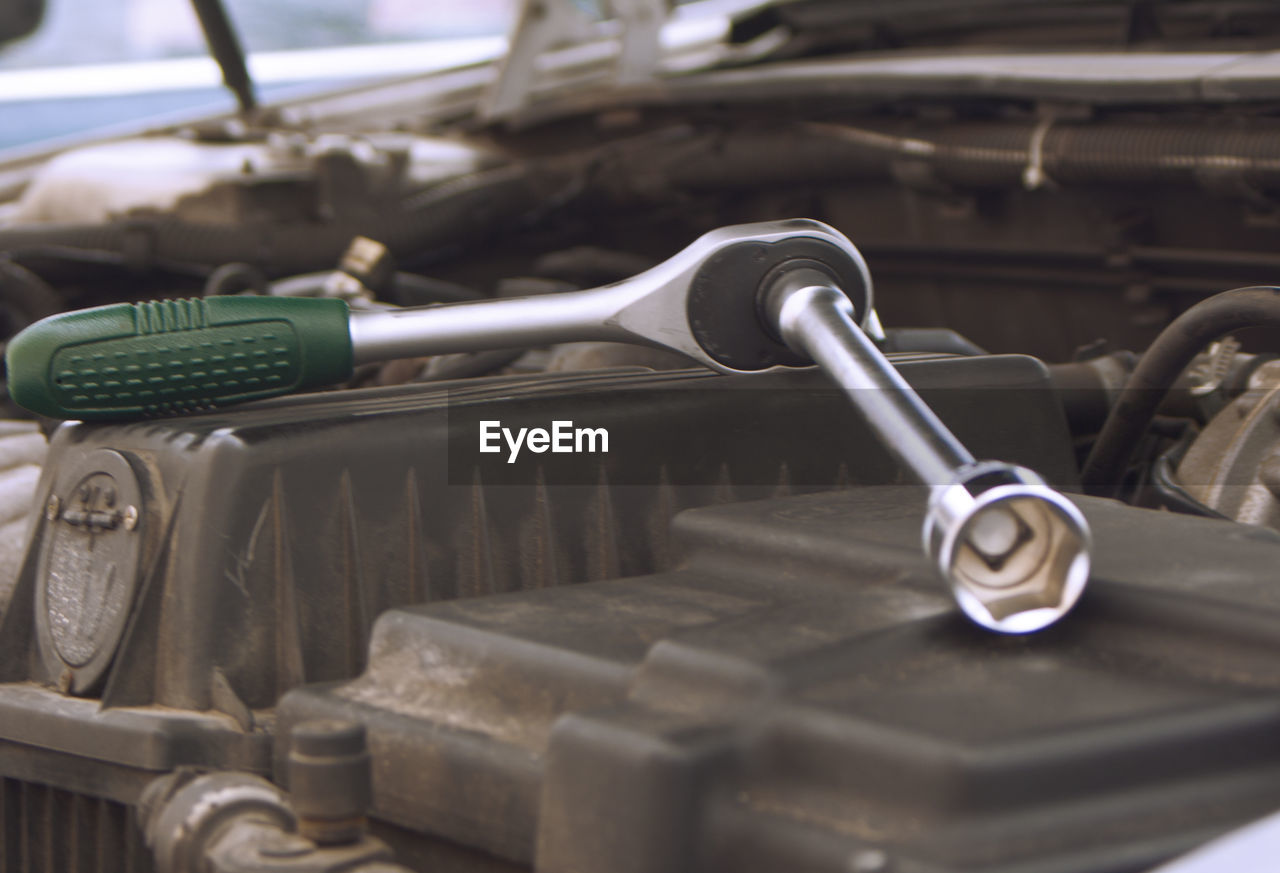 Close-up of adjustable wrench on car engine