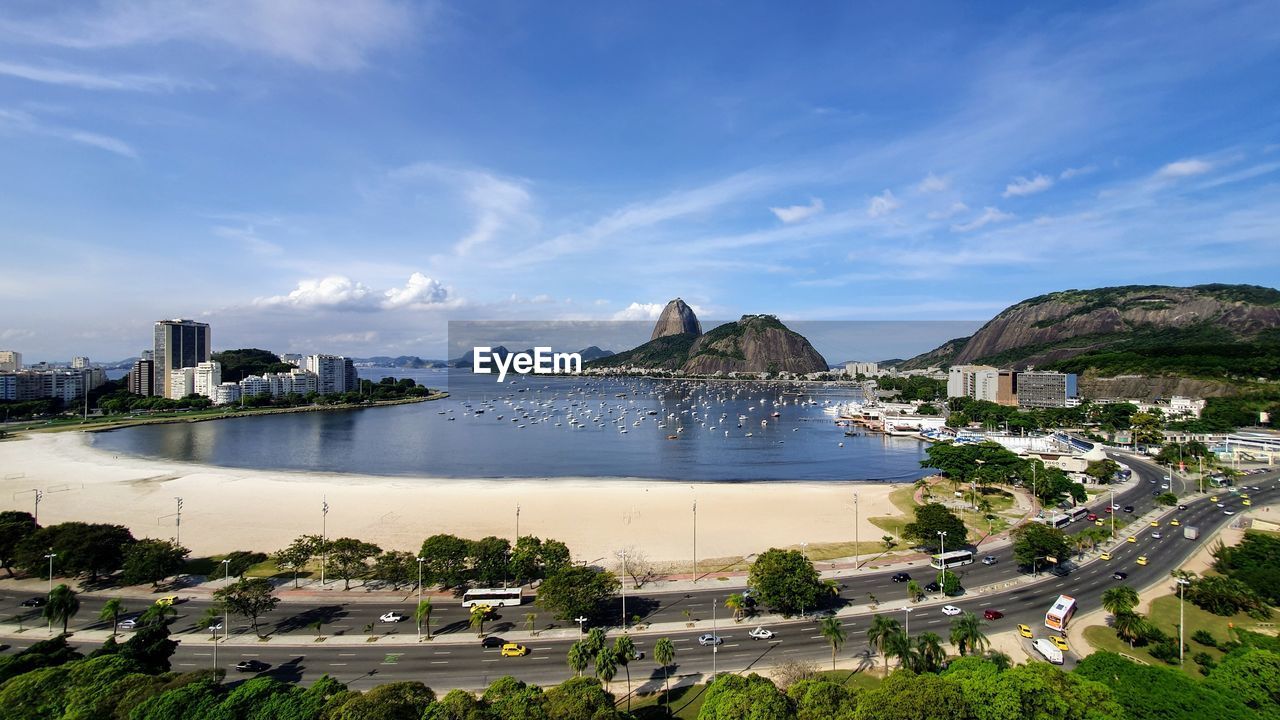 Panoramic shot of city by sea against sky