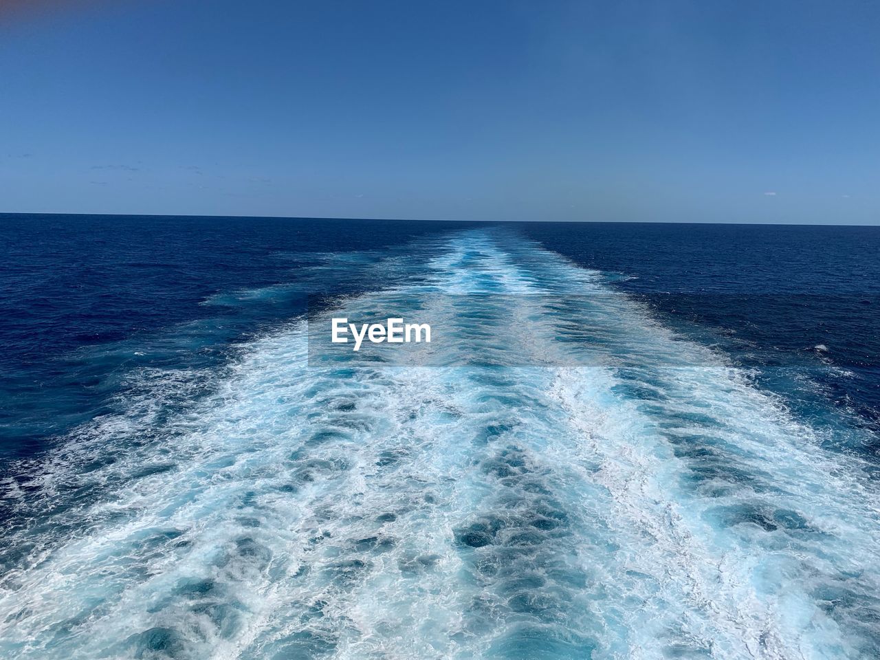 Scenic view of sea against clear blue sky