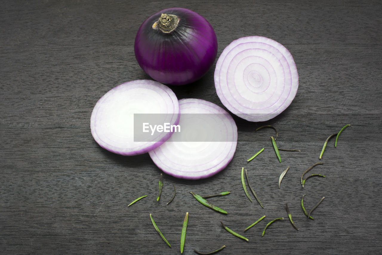 Close-up of onion with rosemary on table