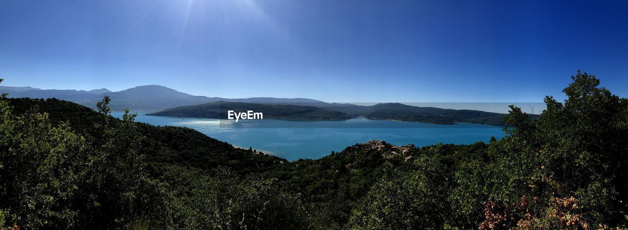 Scenic view of mountains against clear blue sky