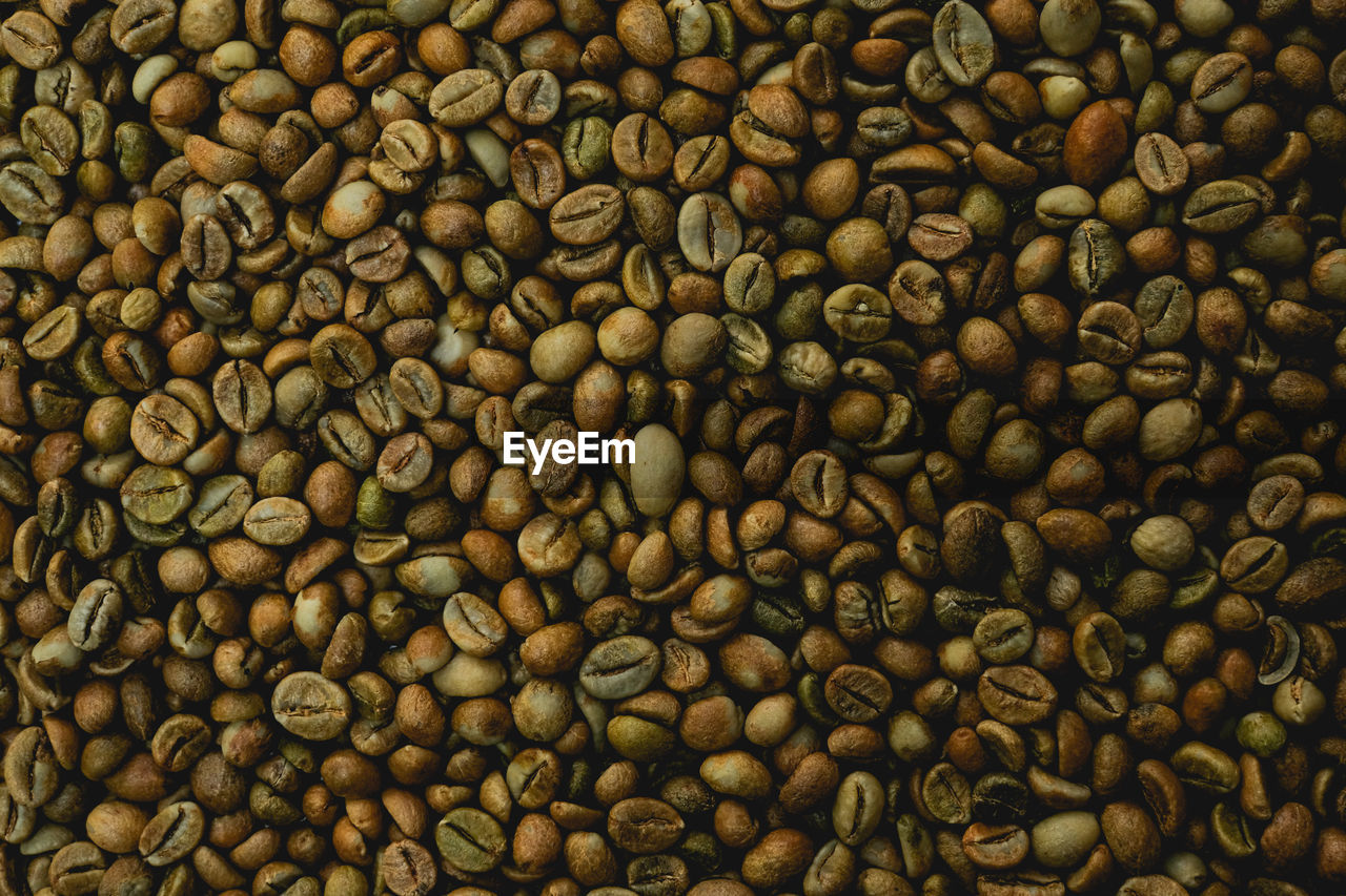 FULL FRAME SHOT OF COFFEE BEANS IN BACKGROUND