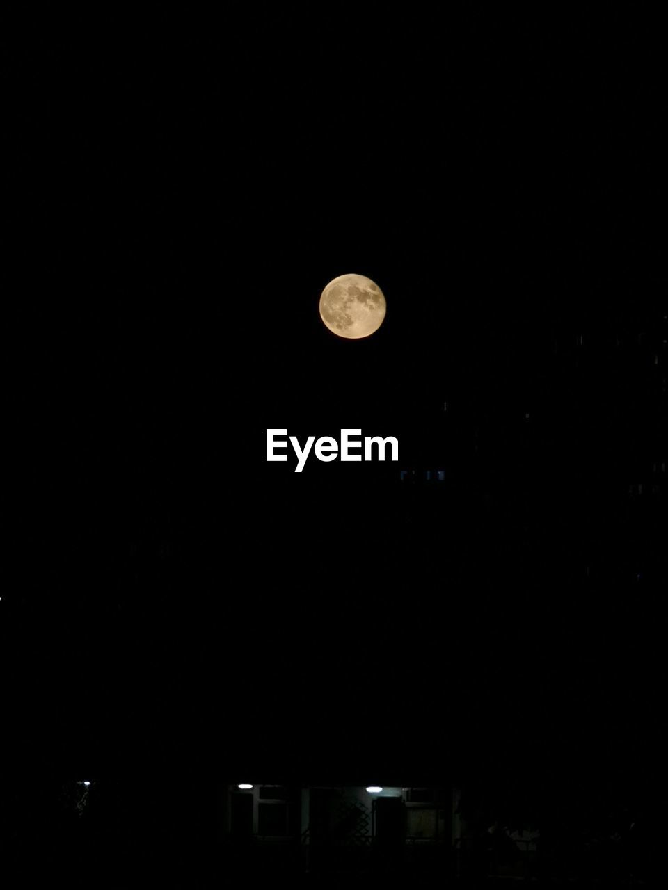 Low angle view of moon against sky at night