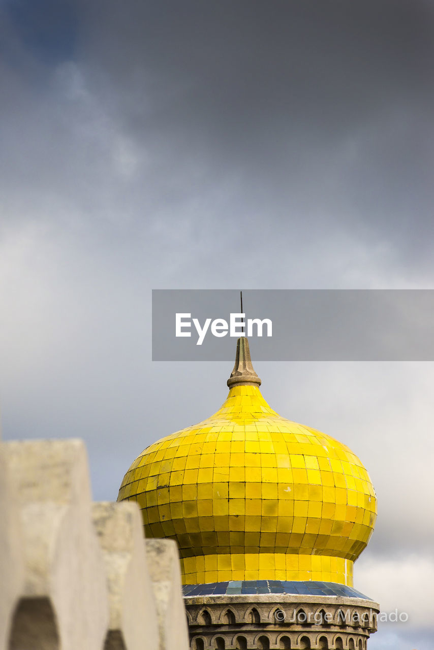 High section of a temple against cloudy sky