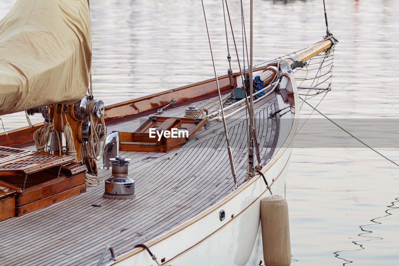 An image shows an old-fashioned yacht docked