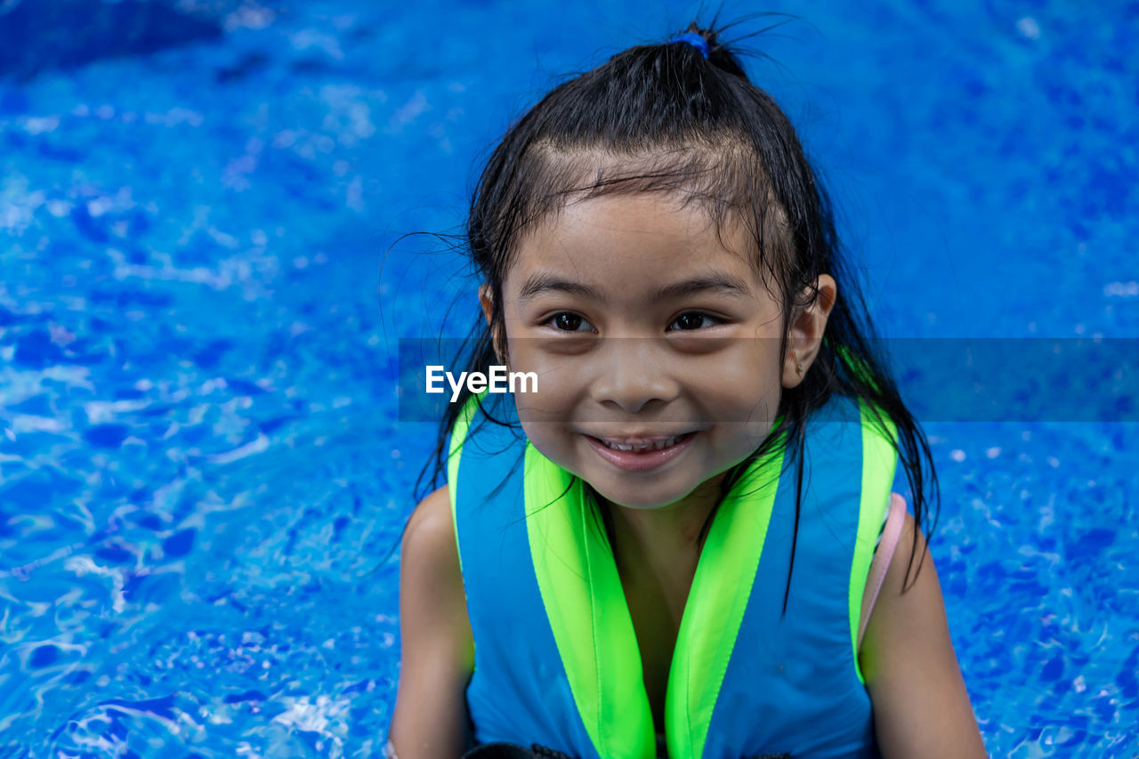 Portrait of smiling girl in swimming pool