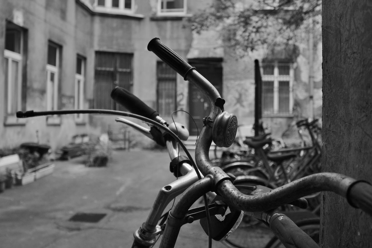 Close-up of bicycle parked on street against buildings in city