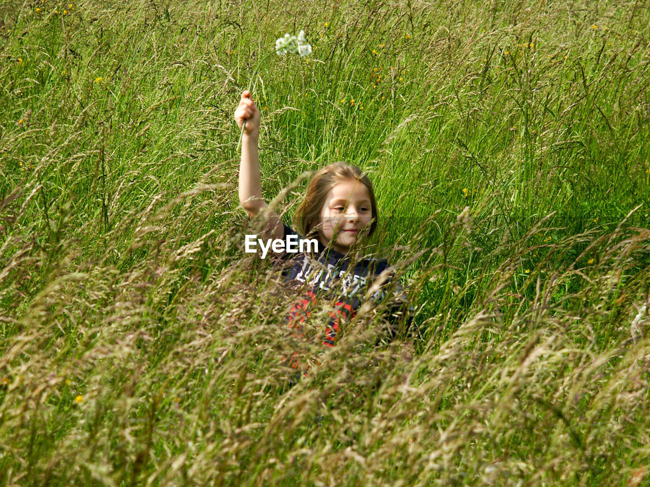 PORTRAIT OF SMILING GIRL WITH GREEN PLANTS