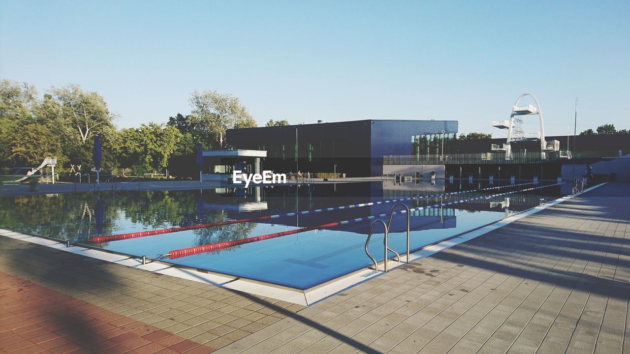 SWIMMING POOL AGAINST CLEAR BLUE SKY