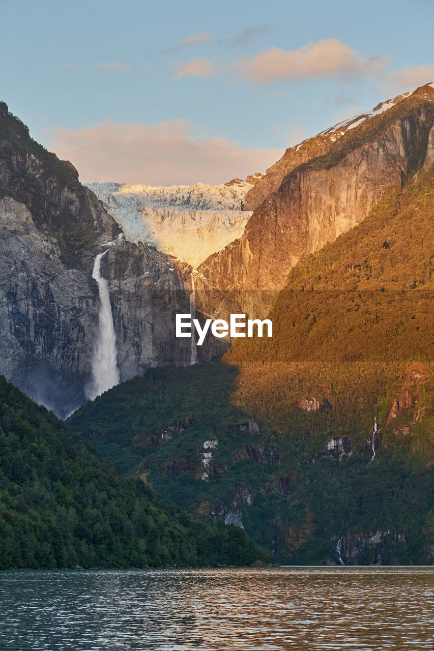 Ventisquero colgante, a hanging glacier with waterfall and lake in queulat national park, chile