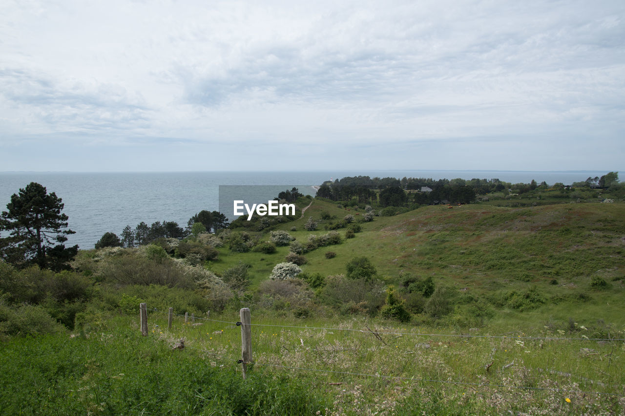 SCENIC VIEW OF SEA AND ROCKS AGAINST SKY