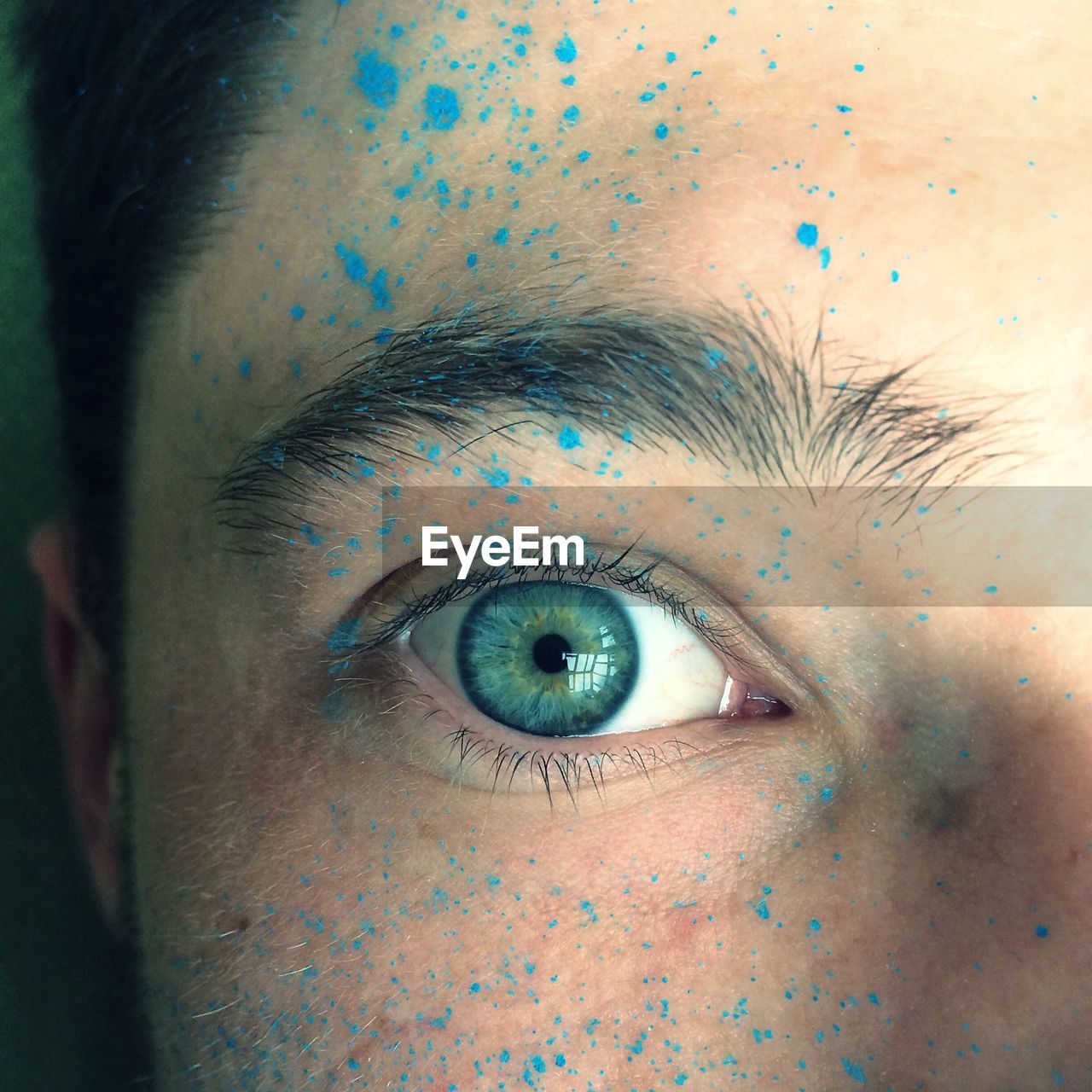 Close-up portrait of man with powder paint