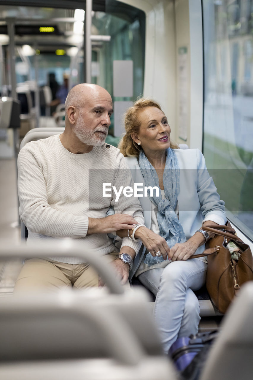 Senior couple sitting in a tram