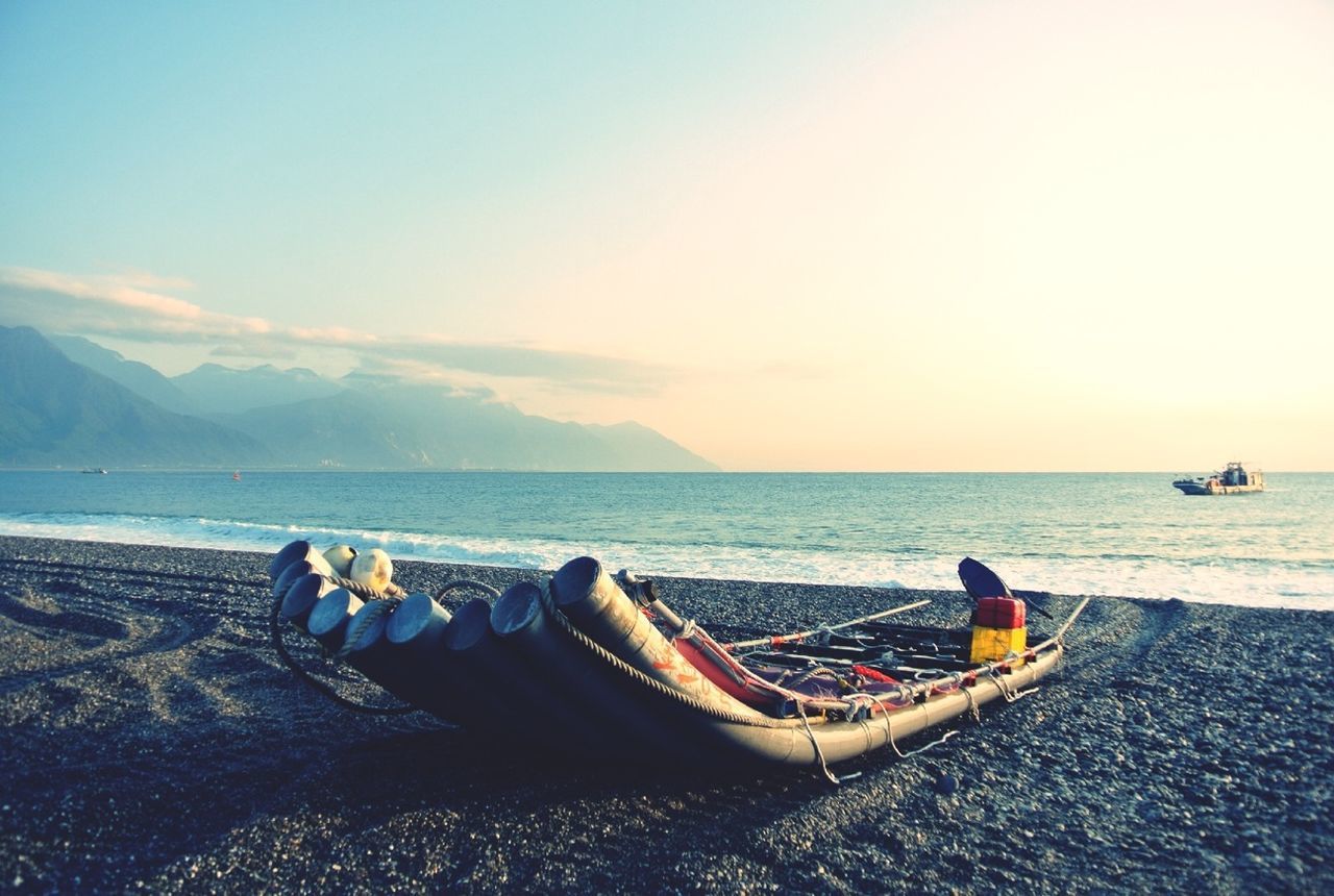 Boat on shore with sea in background