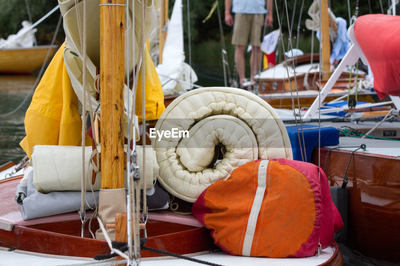 Close-up of luggage near mast on boat