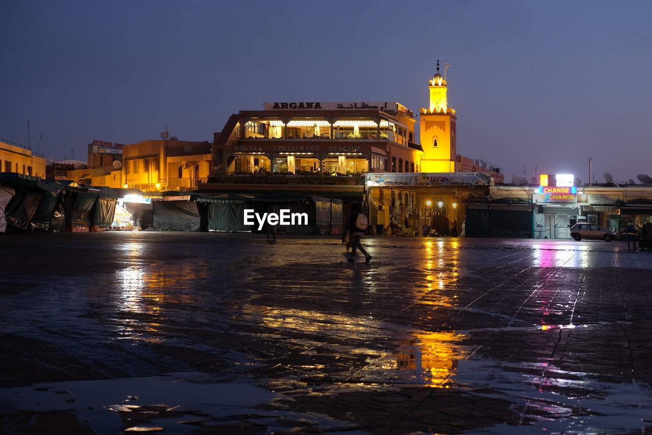 ILLUMINATED BUILDINGS AT WATERFRONT