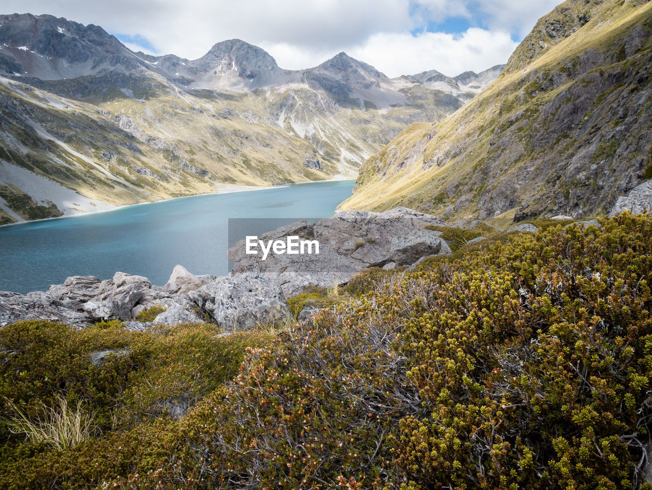 Alpine lake surrounded by mountains, shot at nelson lakes national park, new zealand