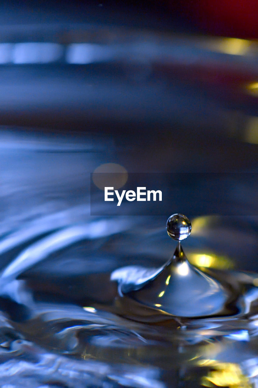 SURFACE LEVEL OF WATER DROP ON RIPPLED LAKE