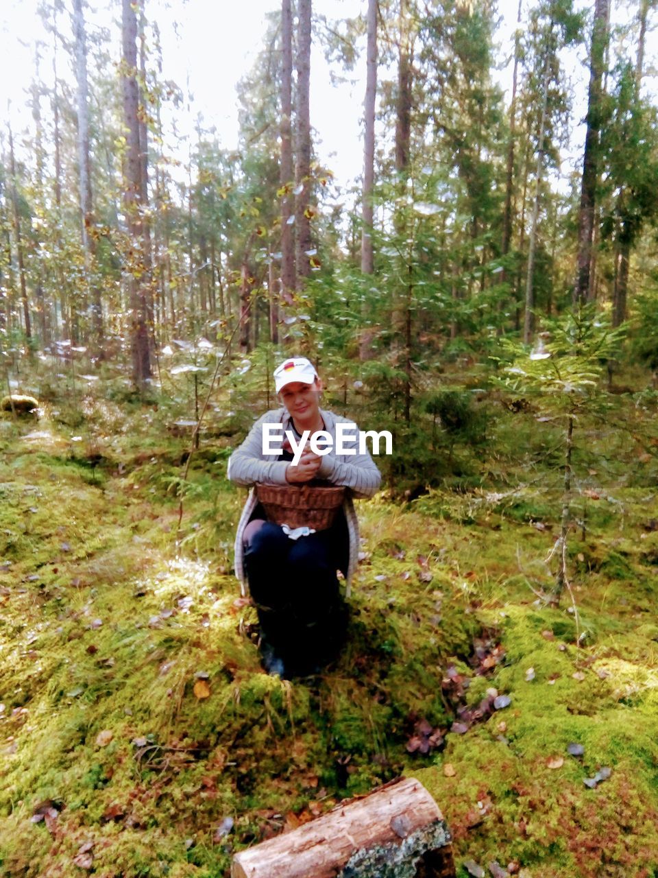 FULL LENGTH OF MAN SITTING IN FOREST