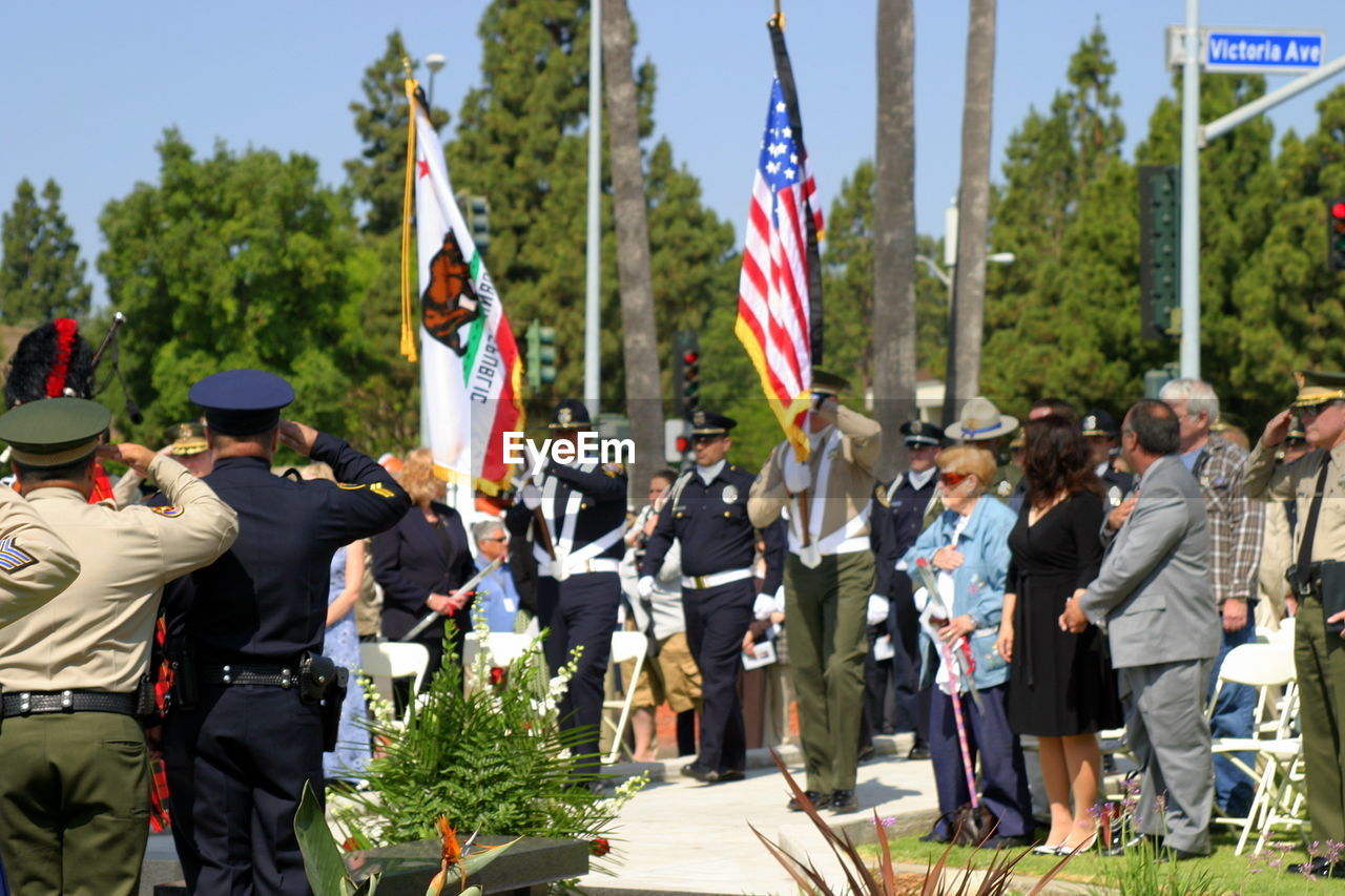 GROUP OF PEOPLE IN FLAGS AT AN ANIMAL