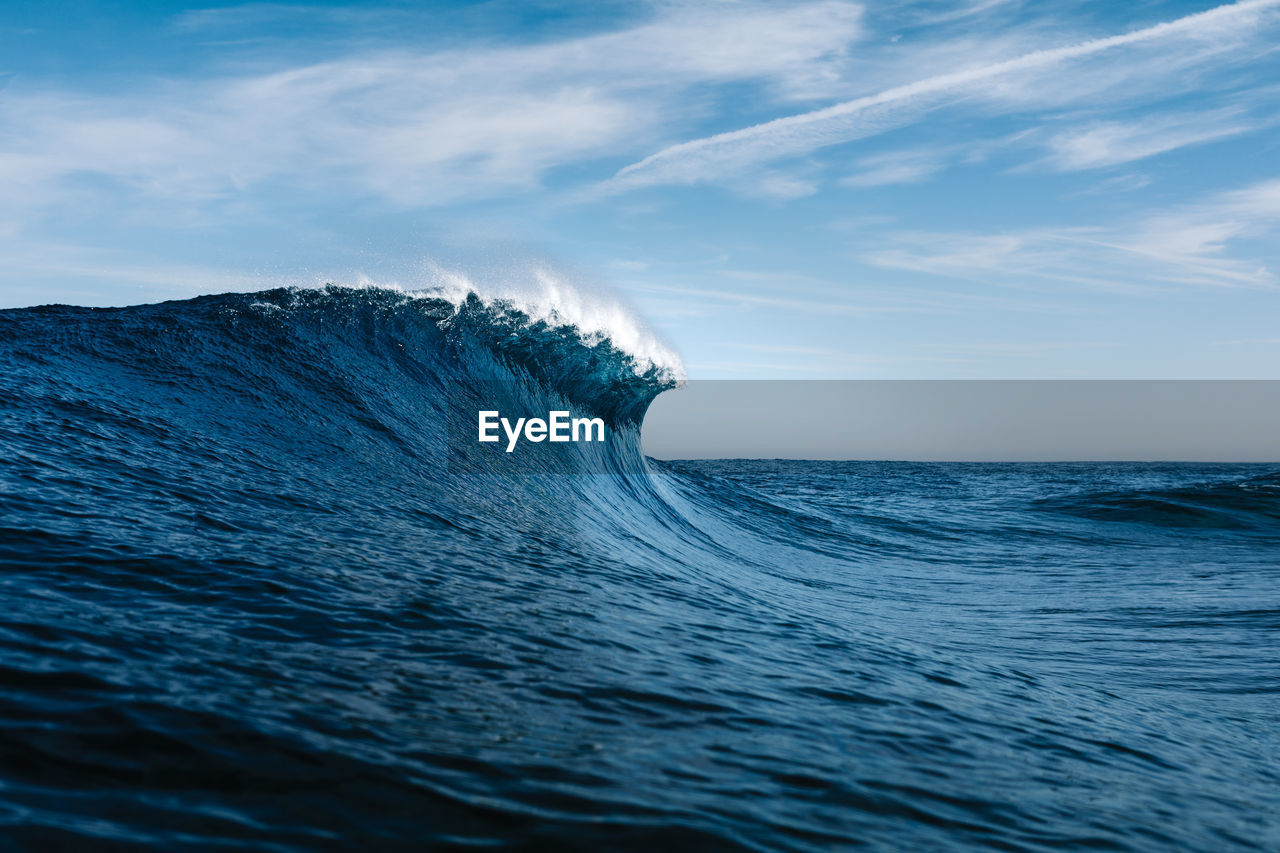 Low angle view of wave in sea against sky