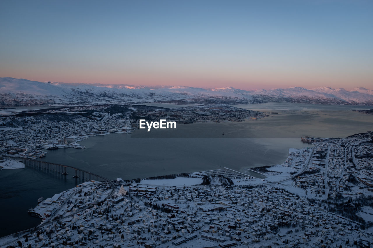 Tromsø norway cityscape in winter covered with snow. view of tromsøysundet strait. aerial shot.