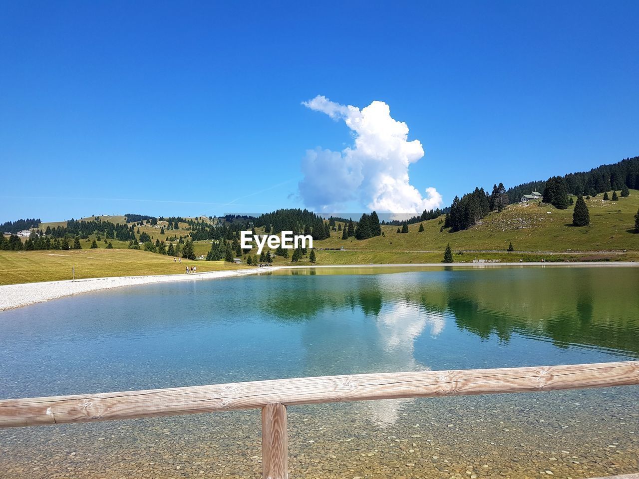 Scenic view of lake against blue sky