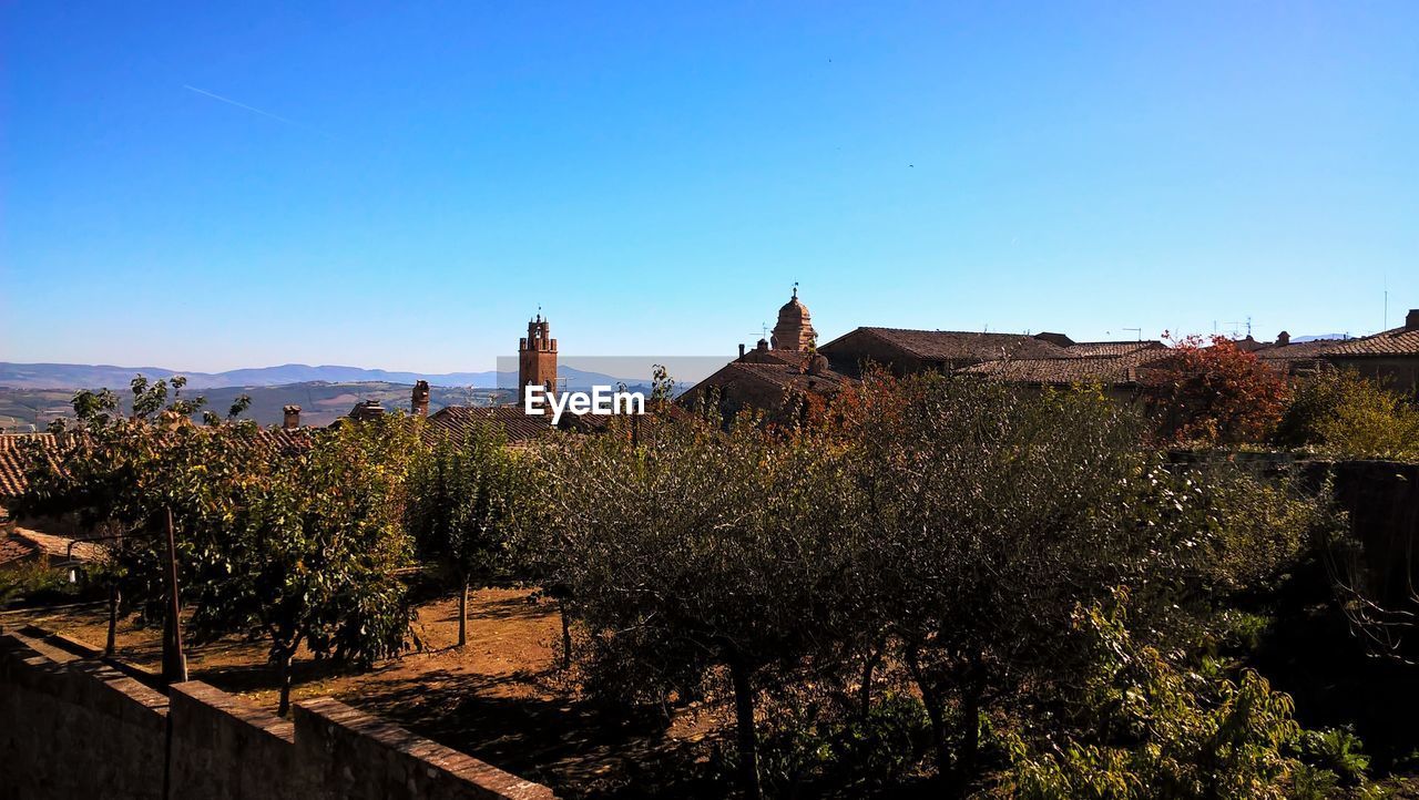 PANORAMIC SHOT OF BUILDING AGAINST CLEAR BLUE SKY