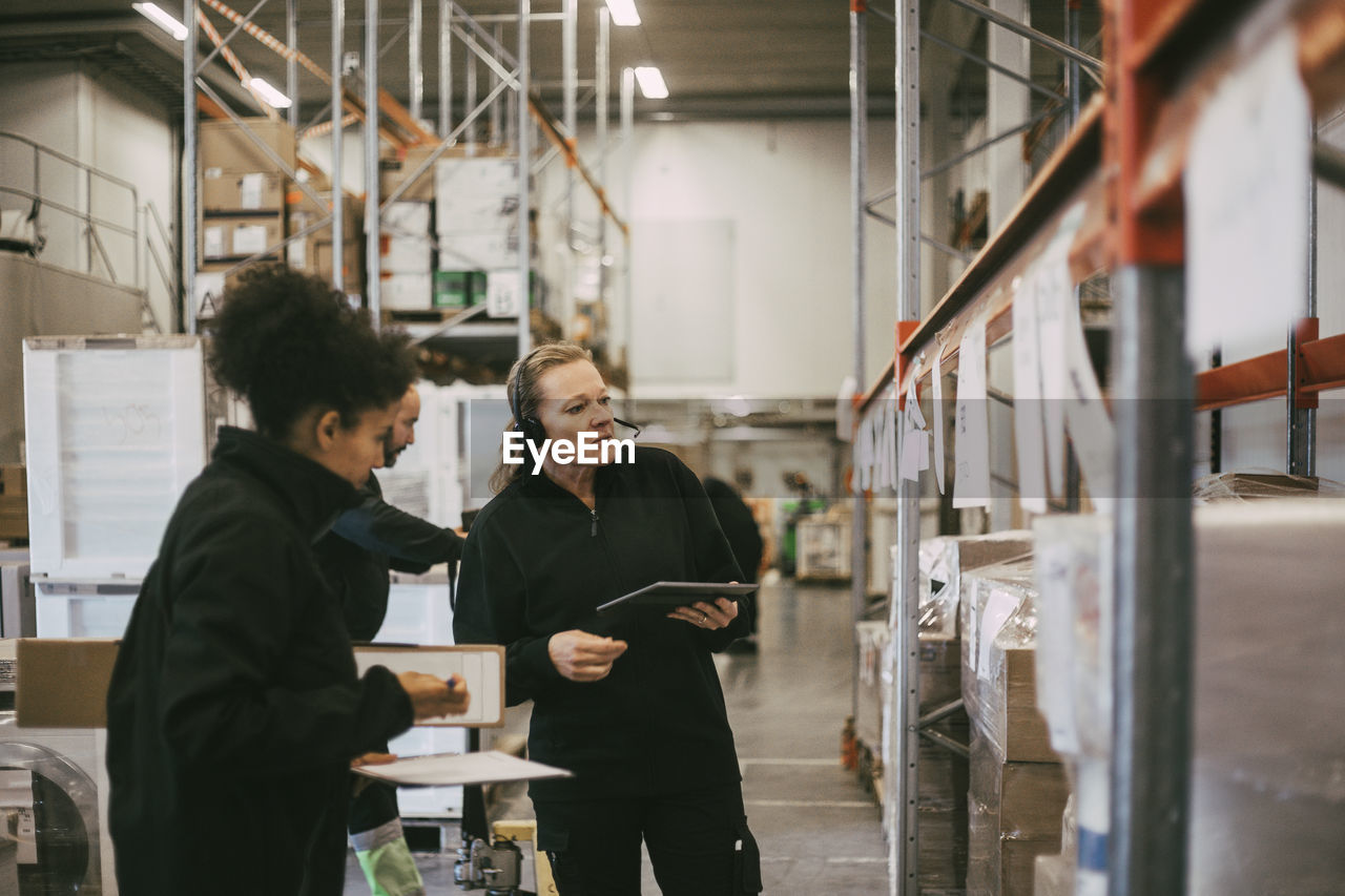 Female coworkers taking inventory at warehouse