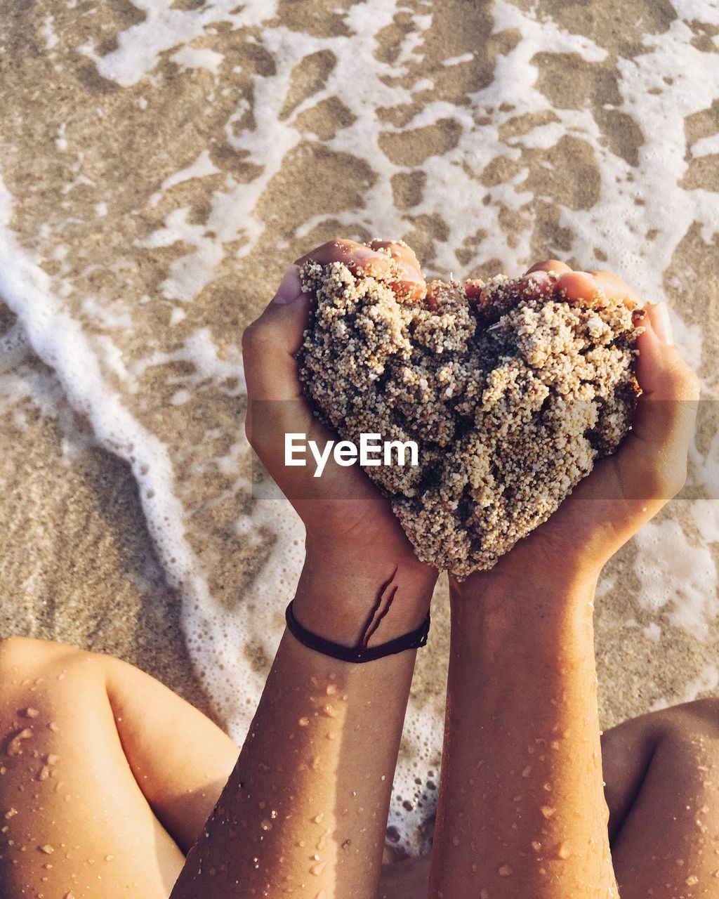 Close-up of woman holding sand