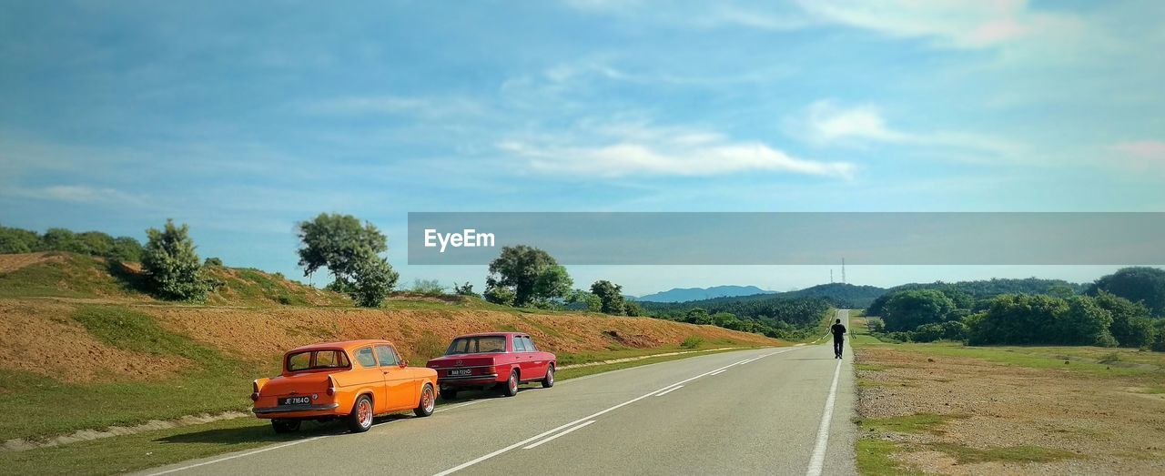 Retro car on empty road in countryside