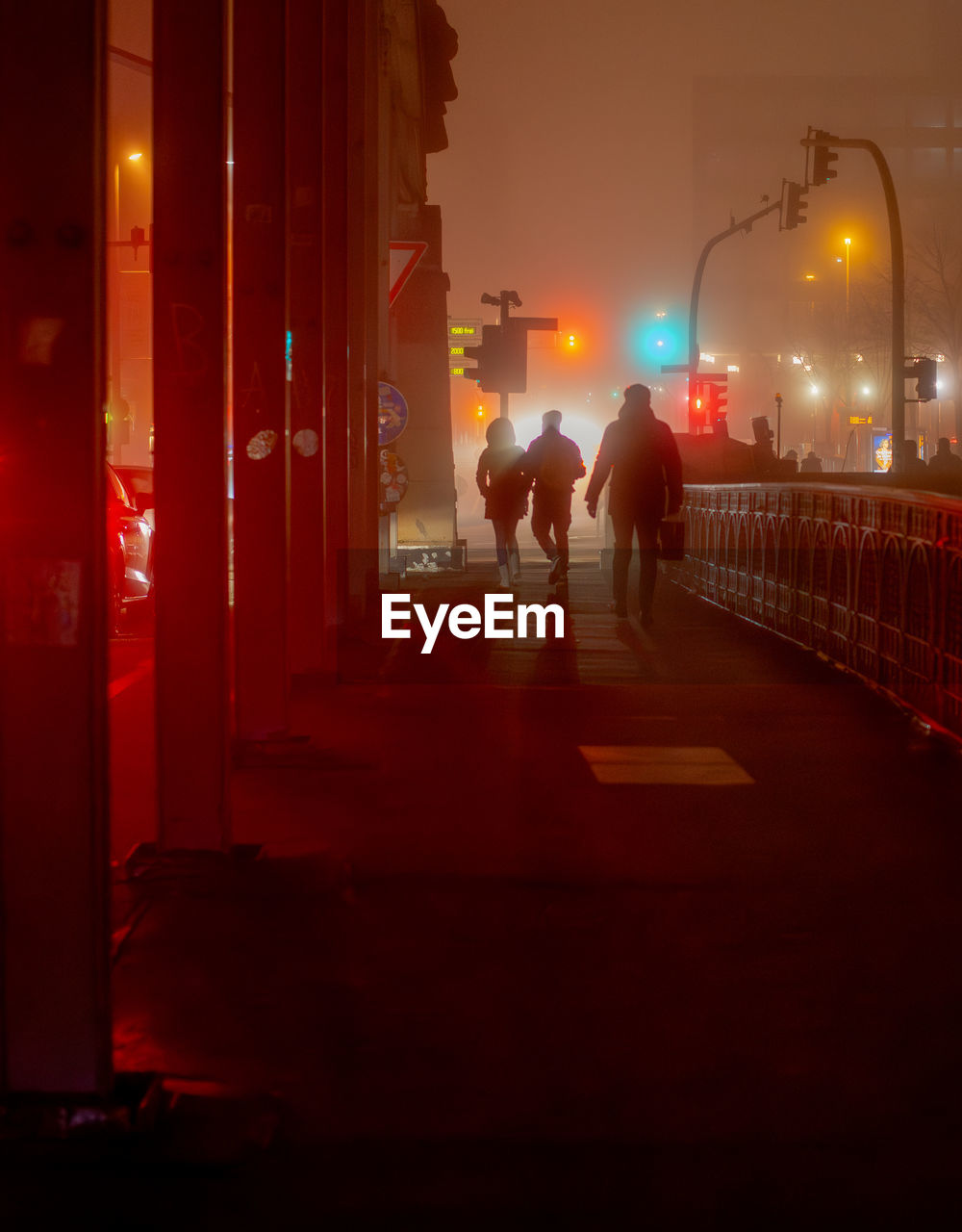 night, red, light, architecture, city, evening, street, illuminated, darkness, street light, transportation, men, lighting, built structure, city life, walking, adult, building exterior, two people, lighting equipment, nature, full length, rear view, fog, outdoors, road, women, mode of transportation, dusk, city street, motion, silhouette
