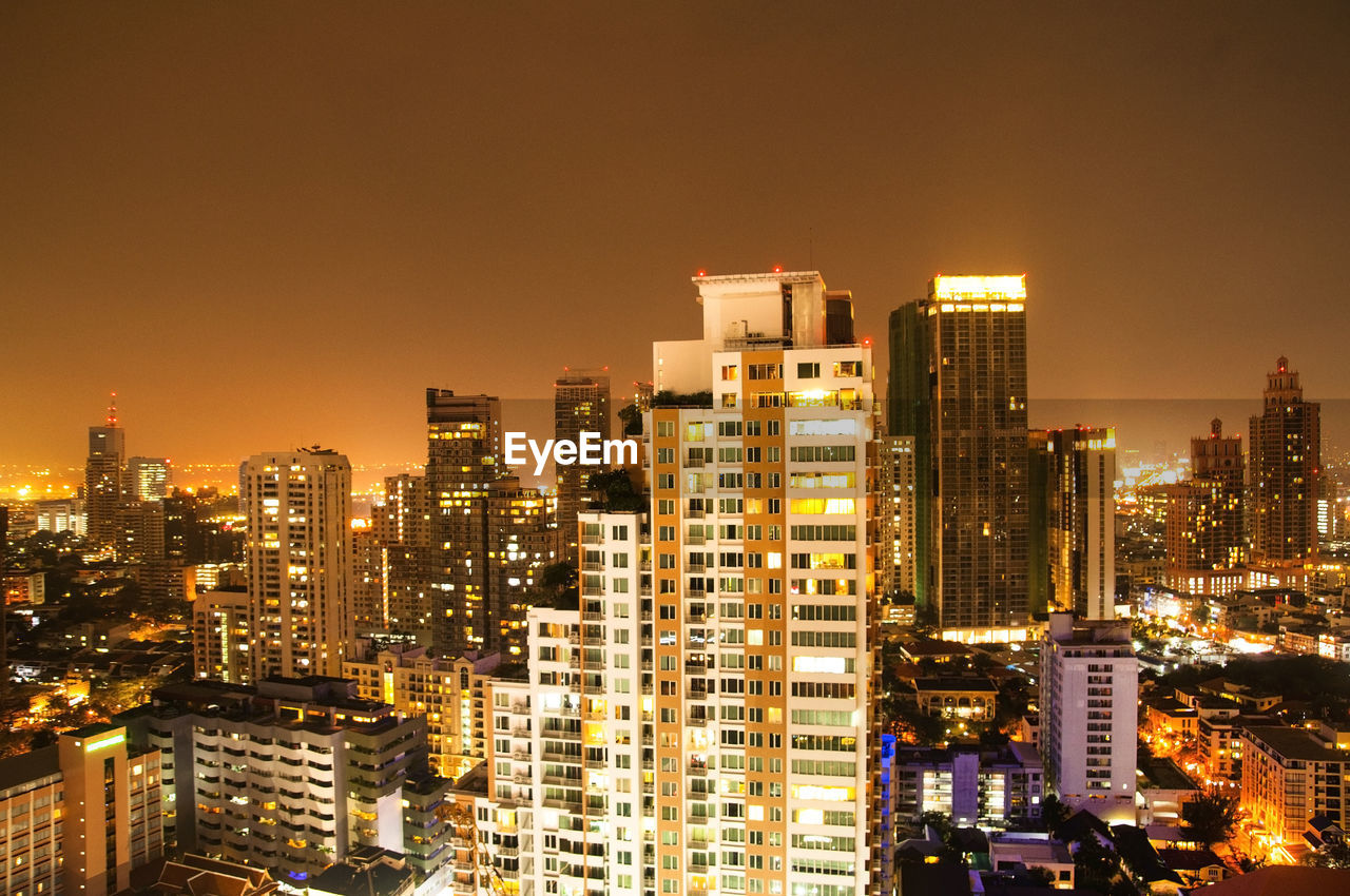 View of skyscrapers lit up at night