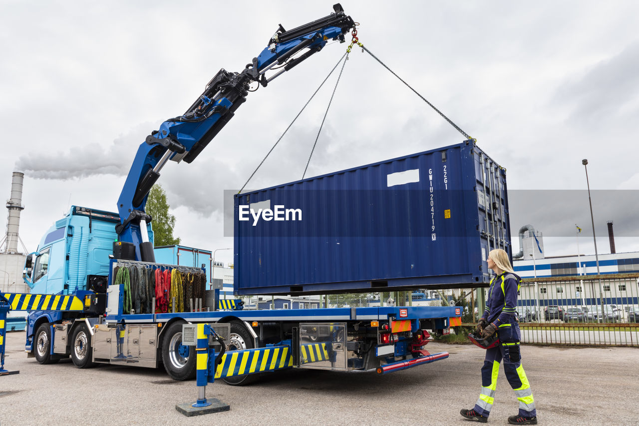 Woman assisting with carrying cargo container