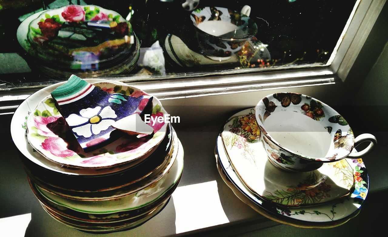 High angle view of plates with design against mirror