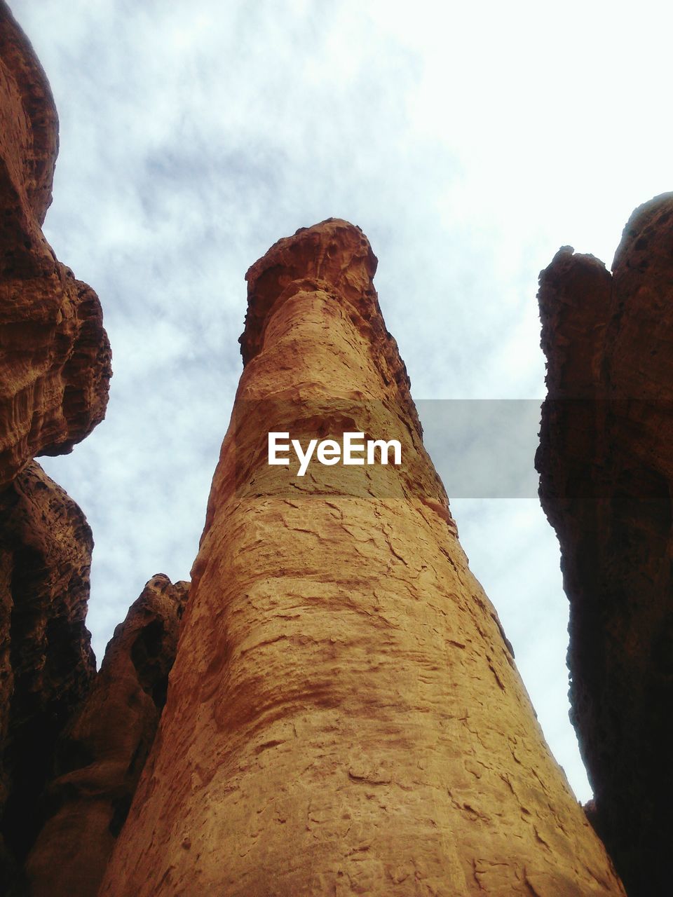 Low angle view of rock formations against sky