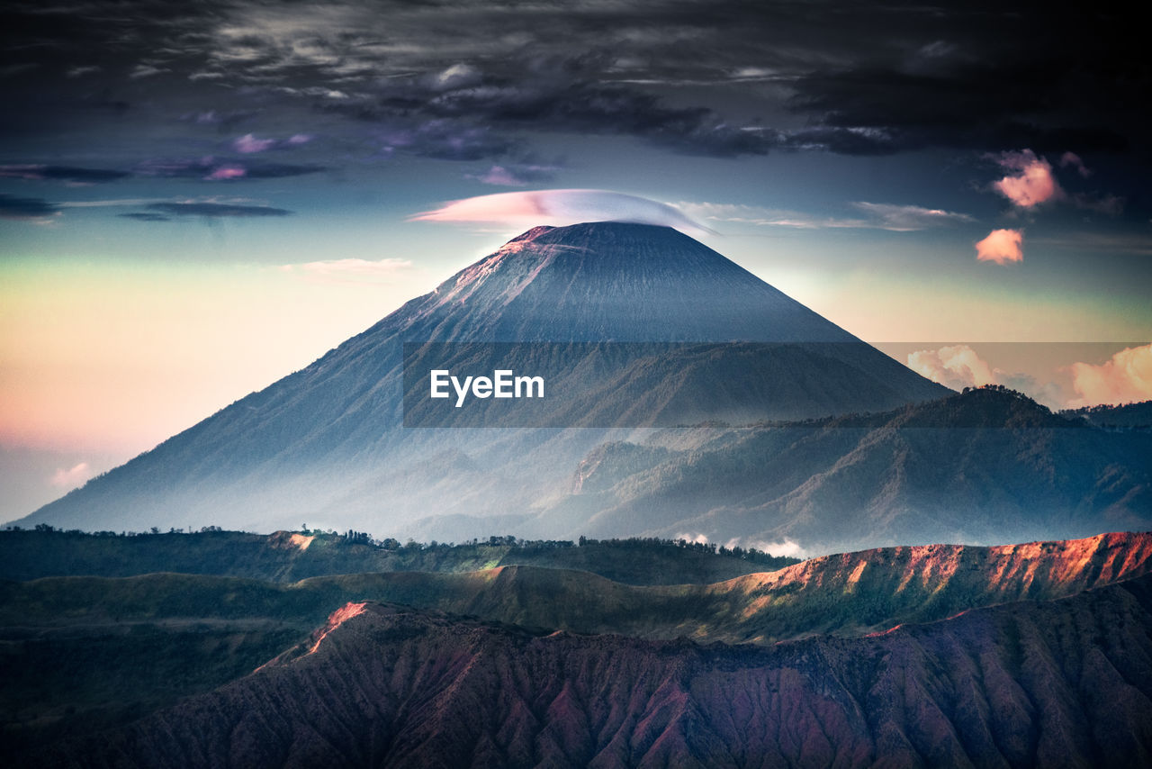 Aerial view of snowcapped mountain against cloudy sky