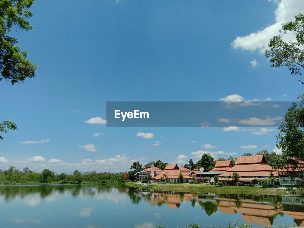 Scenic view of lake by building against sky