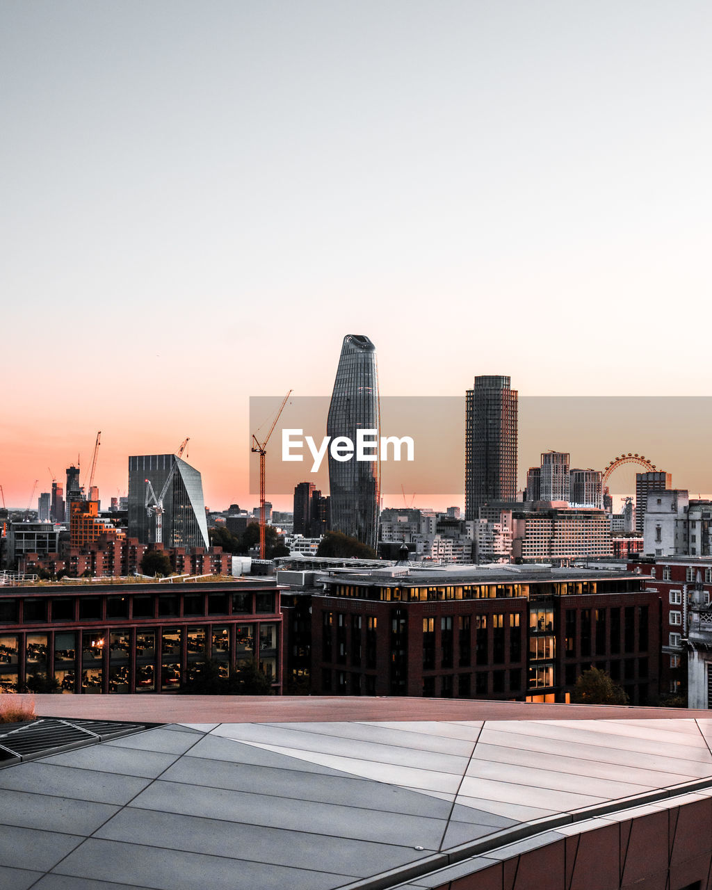 MODERN BUILDINGS AGAINST SKY DURING SUNSET