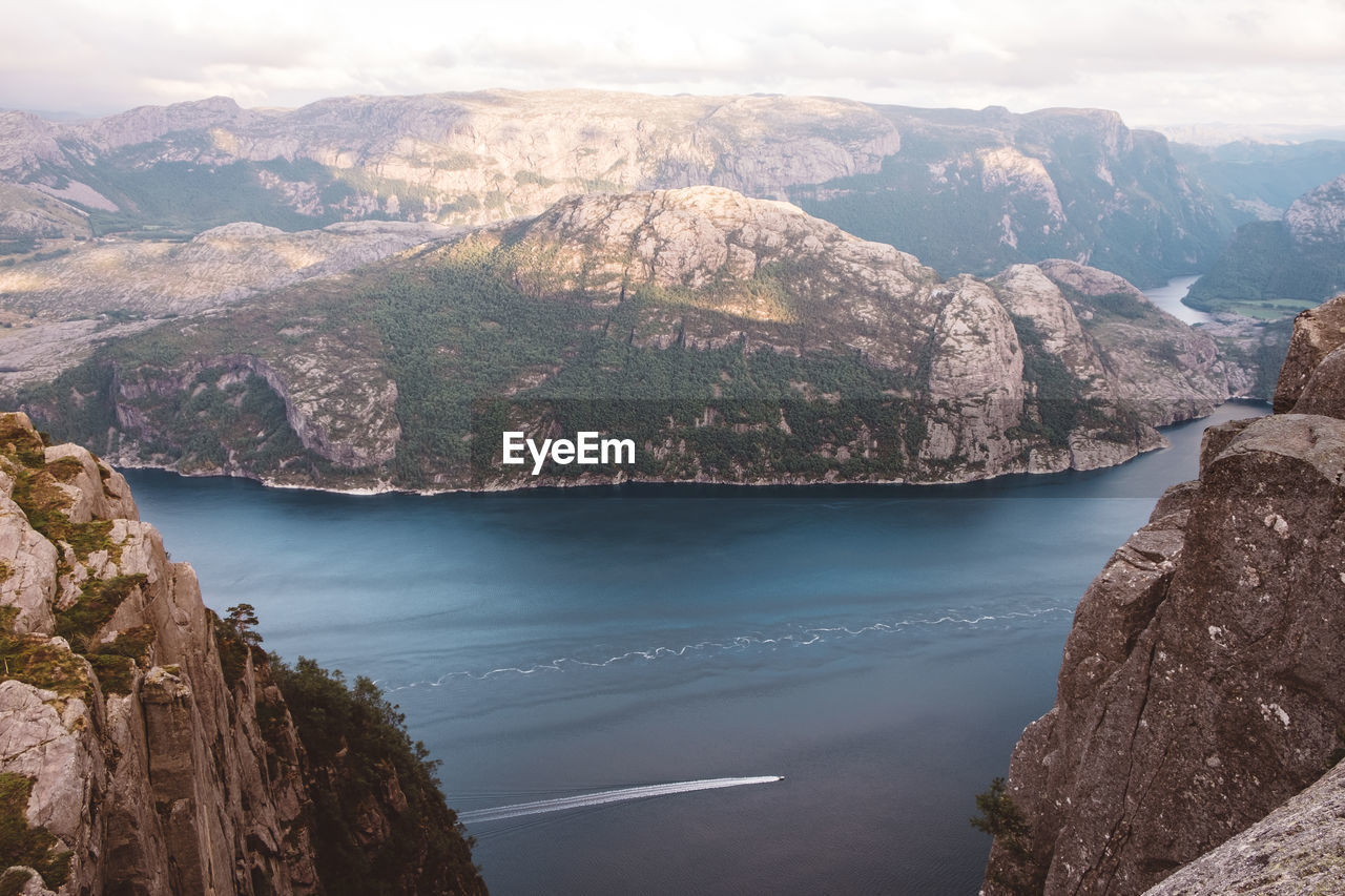 High view of boat cruising through fjords in norway