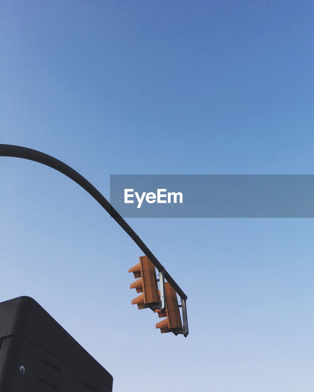 Low angle view of road signal against clear sky