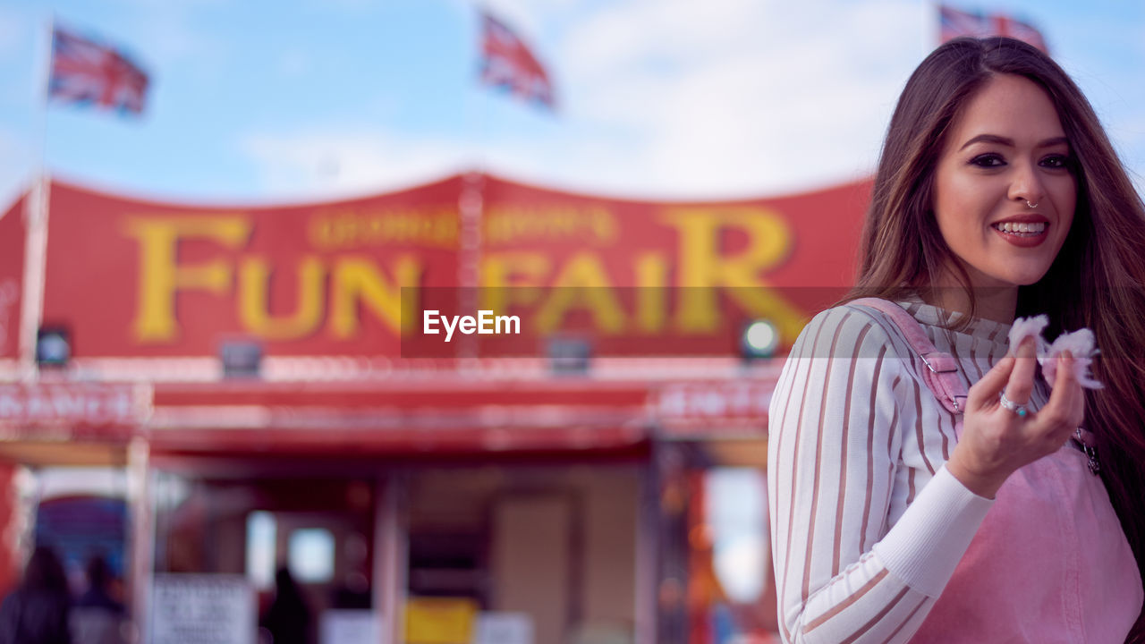 Portrait of a smiling young woman in amusement park