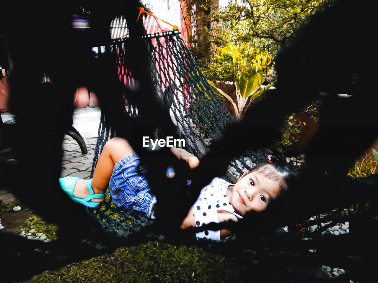 Portrait of cute girl relaxing on hammock